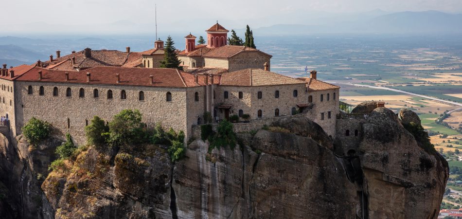 Meteora-Greece.-Saint-Stephen-Agios-Stefanos-Monastery-buildings-on-top-of-rocks-blur-Kalambaka-valley-background.-Europe-religion-travel-destination-950x450